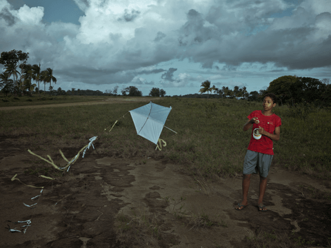 Caio competes with his brother, Gabriel (not pictured), to see who can fly their kite higher.