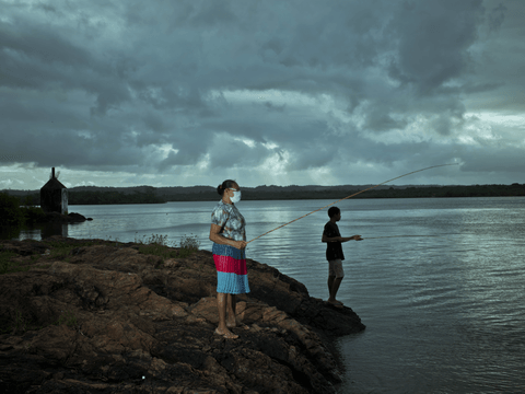 Caio fishes with his grandmother, María.