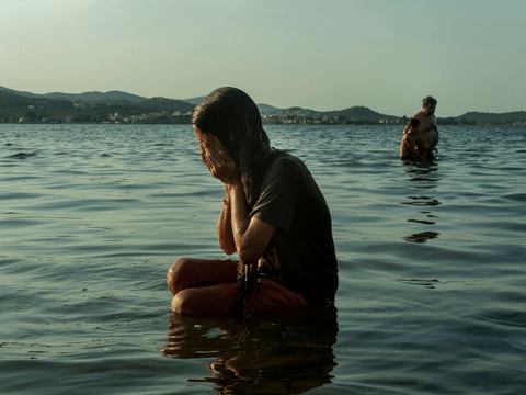 Manija bathes in the Aegean Sea, at Kara Tepe camp.