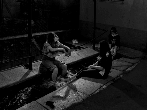 Anna, Clarissa and Chiara socialize in the town centre.