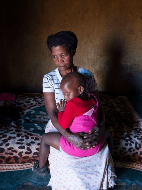 Bunam cuddles with her grandmother.