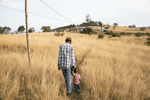 Indamkele takes a walk with his father.