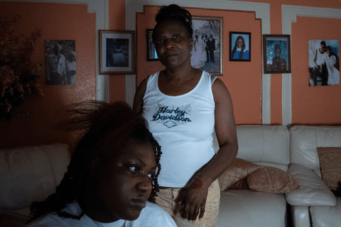 Elaine does her daugther Julissa's hair in the living room of the family home.